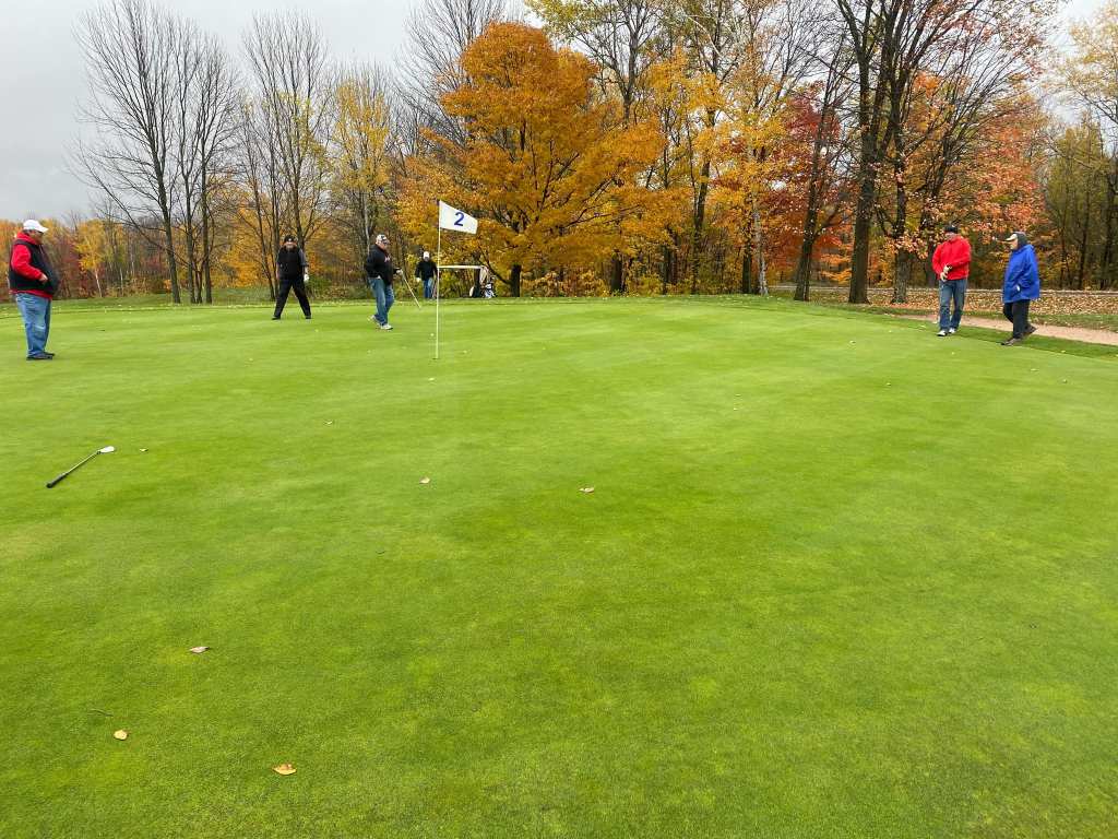 Golfers on golf course in autumn